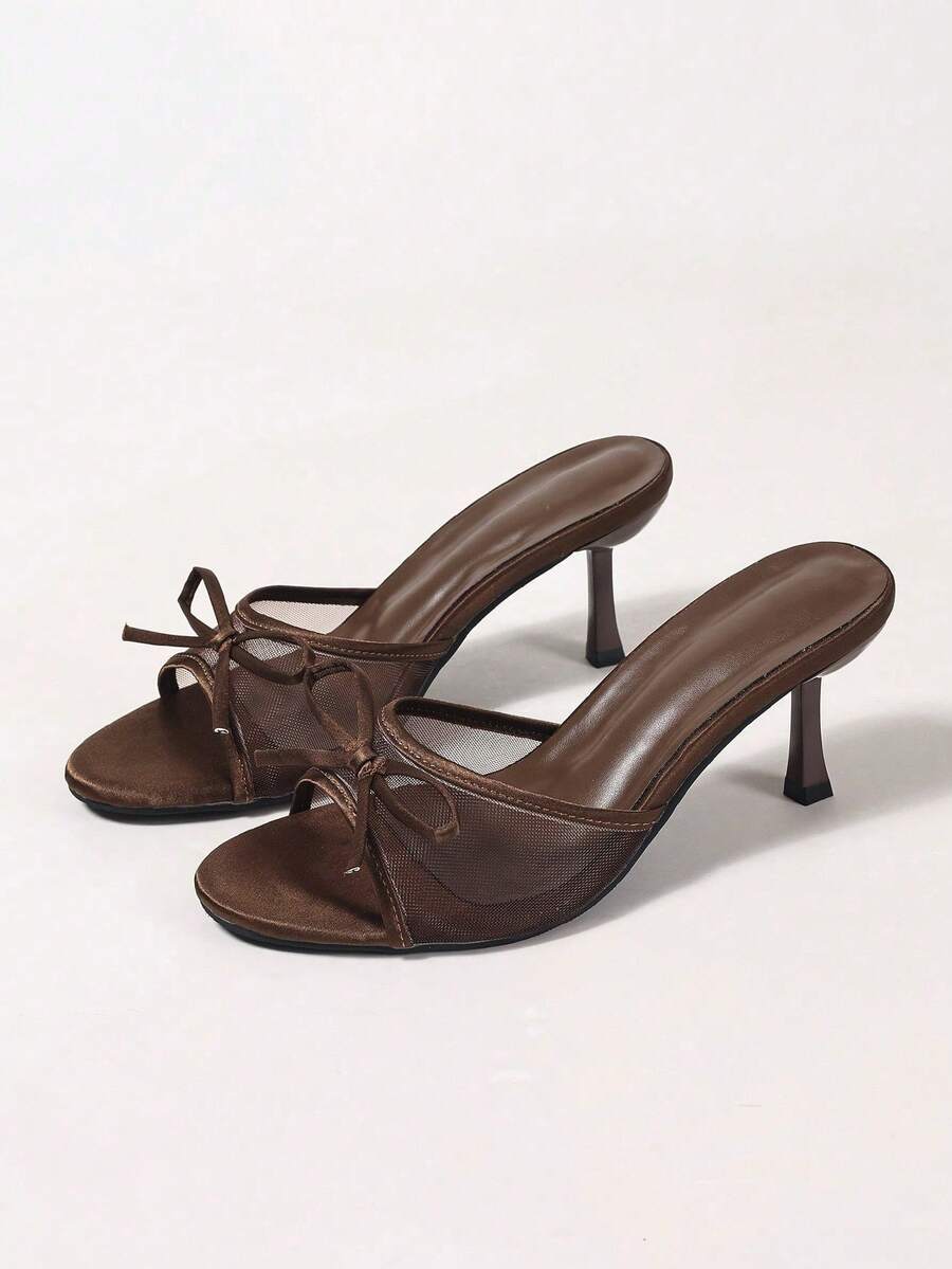 Women's black open toe mesh slide sandals with bowknot detail and stiletto heels