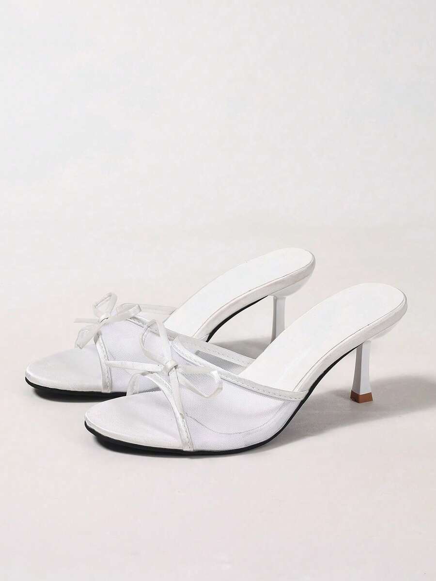 Women's black open toe mesh slide sandals with bowknot detail and stiletto heels