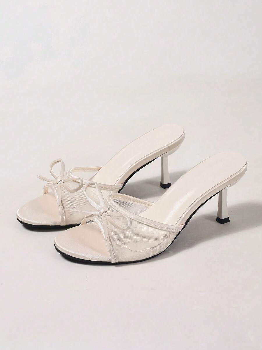 Women's black open toe mesh slide sandals with bowknot detail and stiletto heels
