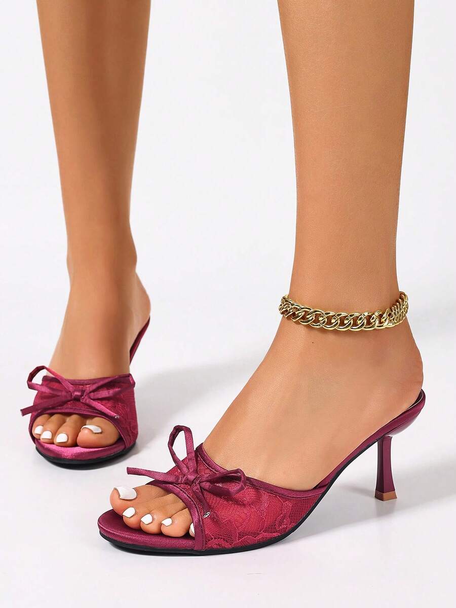 Women's black open toe mesh slide sandals with bowknot detail and stiletto heels