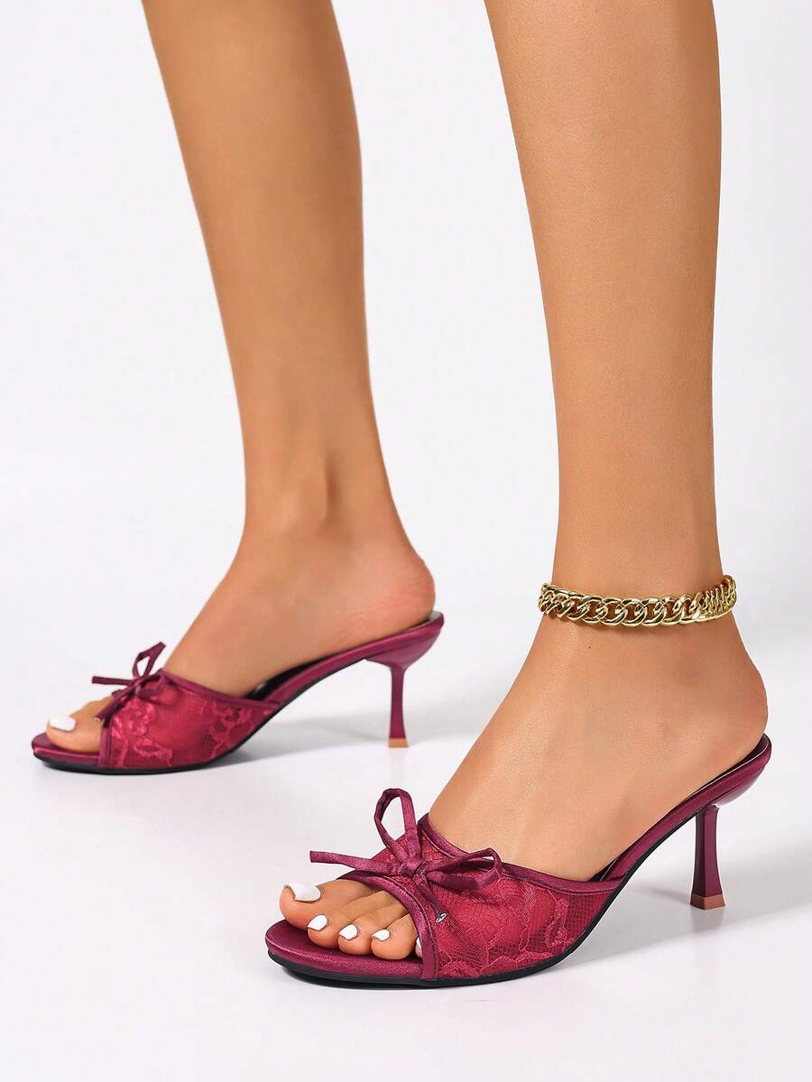 Women's black open toe mesh slide sandals with bowknot detail and stiletto heels