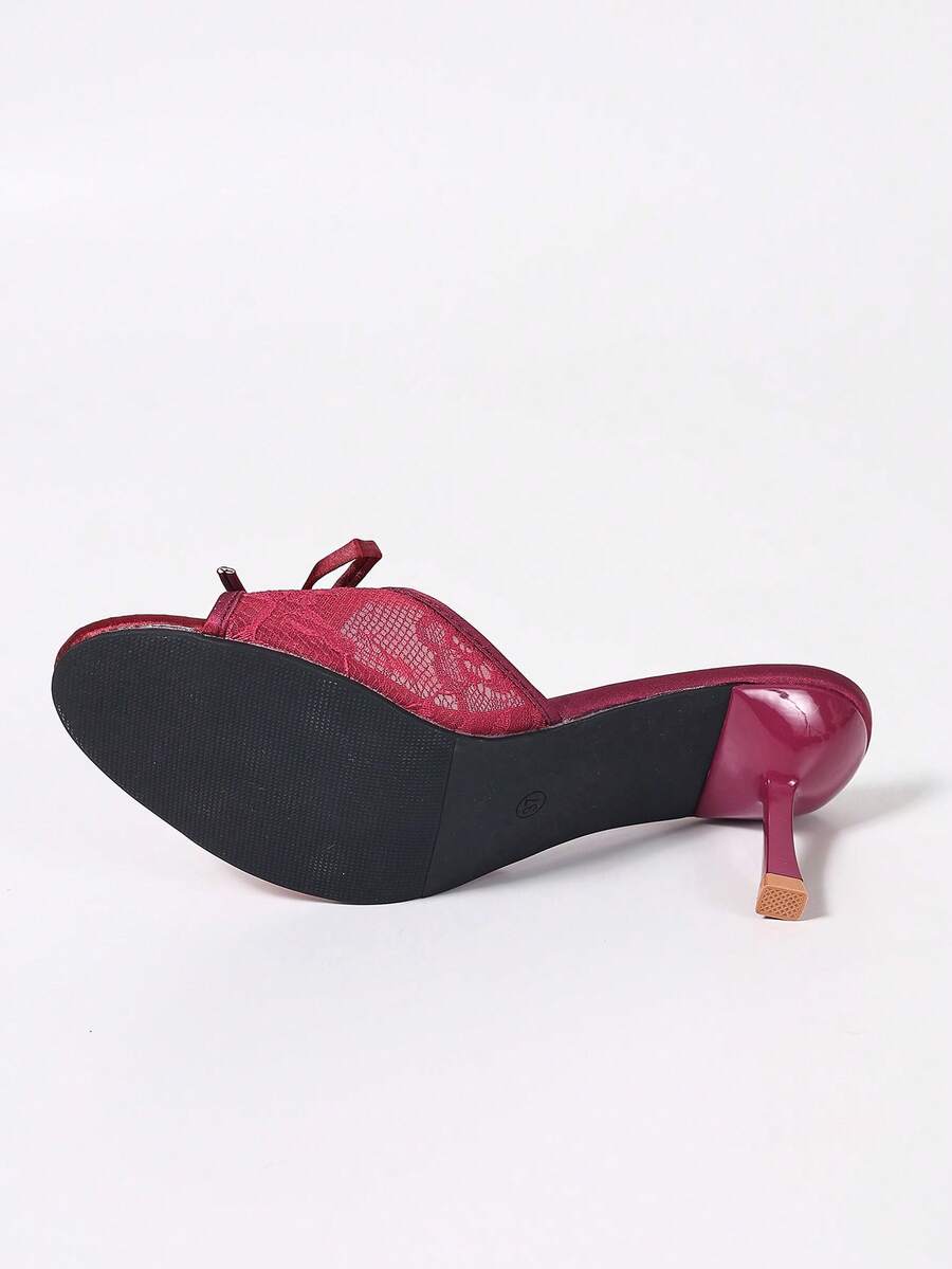 Women's black open toe mesh slide sandals with bowknot detail and stiletto heels