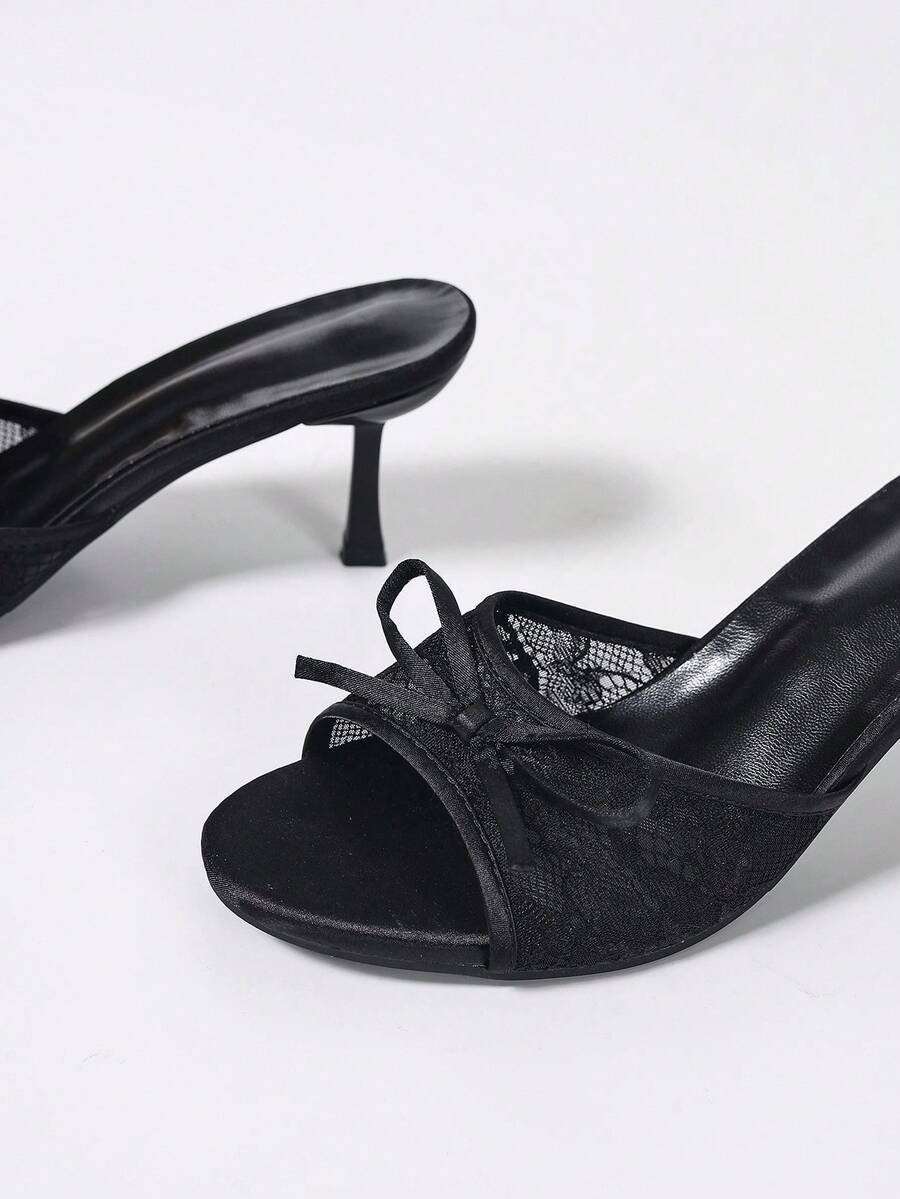 Women's black open toe mesh slide sandals with bowknot detail and stiletto heels