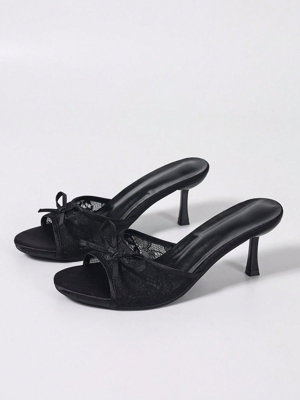 Women's black open toe mesh slide sandals with bowknot detail and stiletto heels