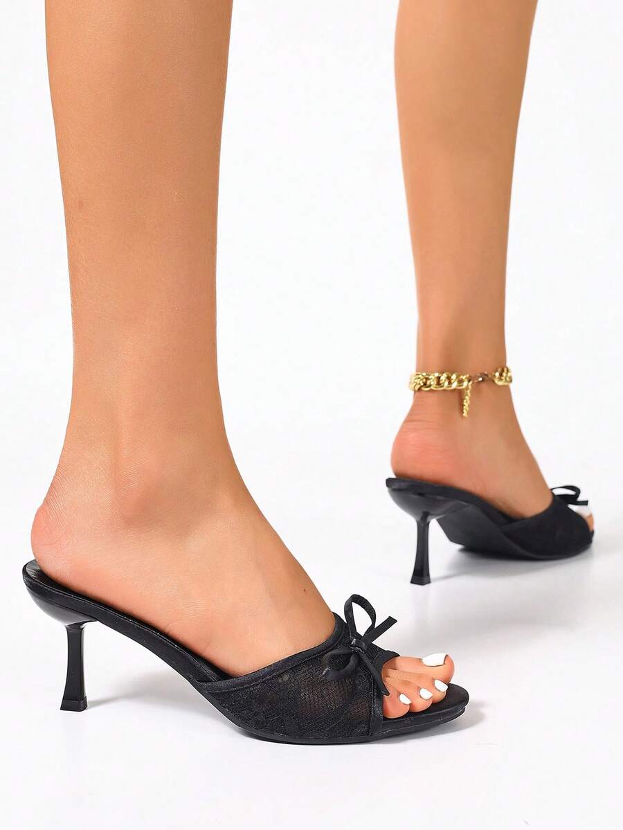 Women's black open toe mesh slide sandals with bowknot detail and stiletto heels