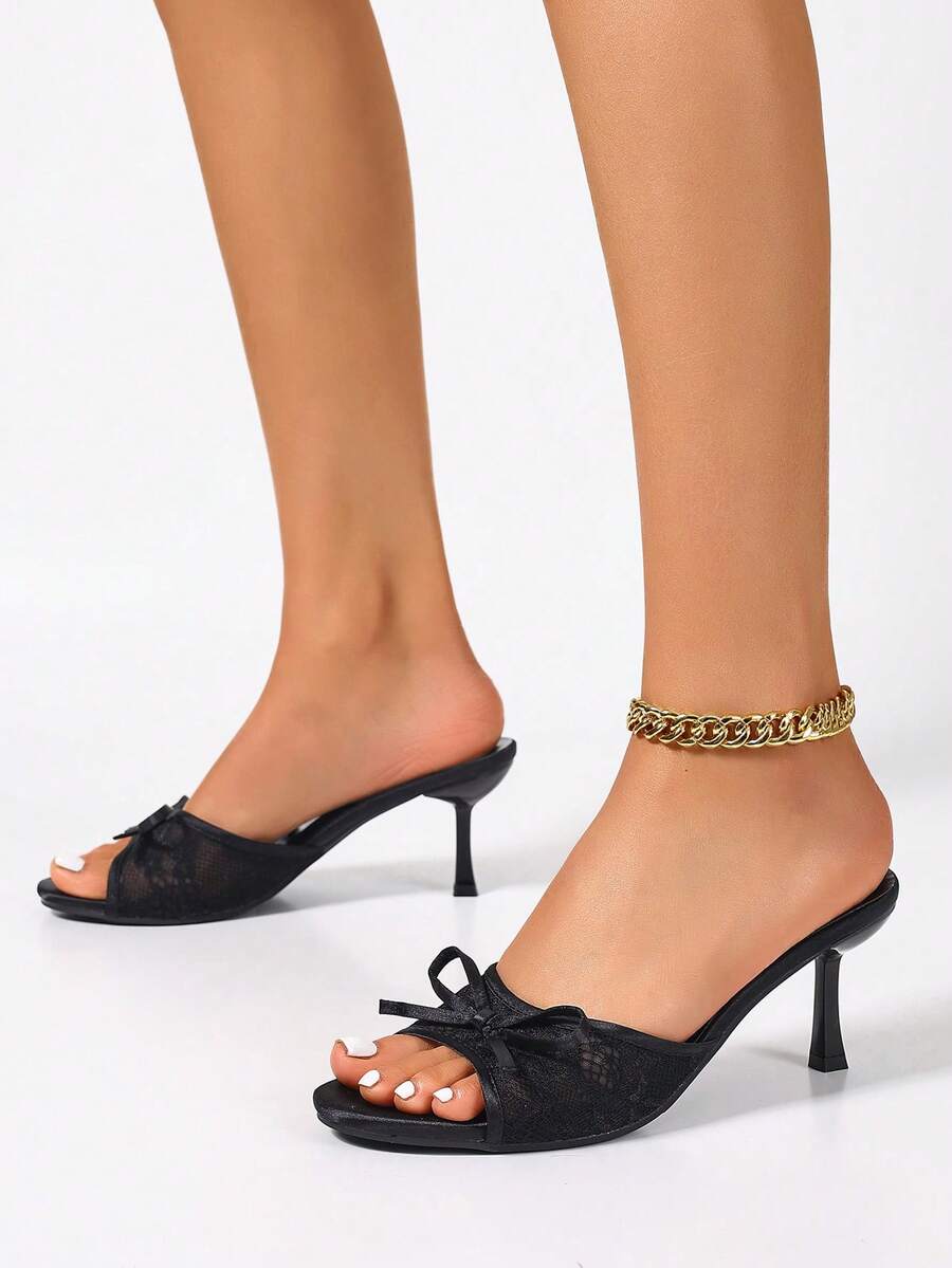 Women's black open toe mesh slide sandals with bowknot detail and stiletto heels