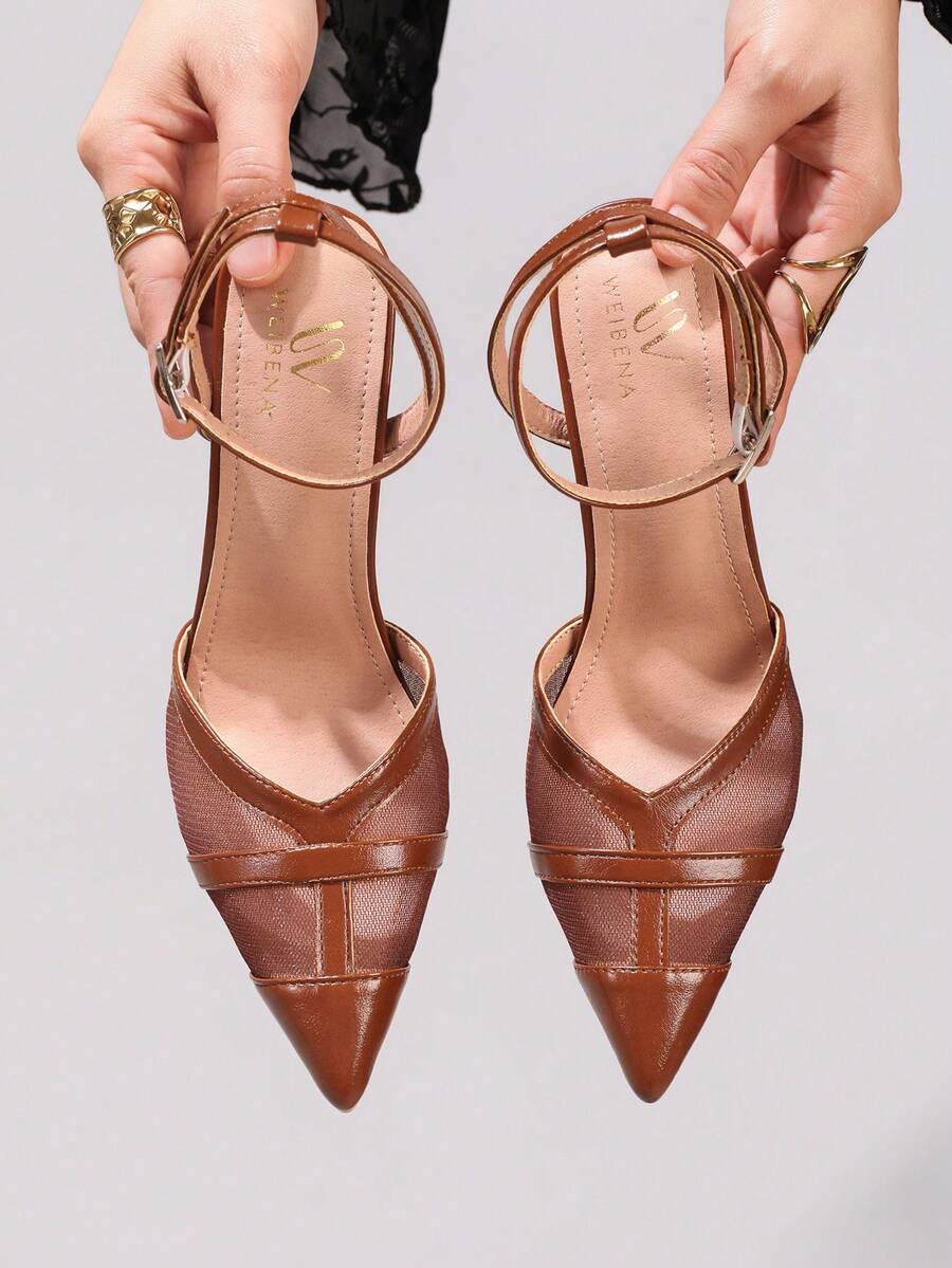 Lace embroidered high heels with thin stiletto heel, pointed toe, rhinestone embellishments, and ankle strap buckle closure.