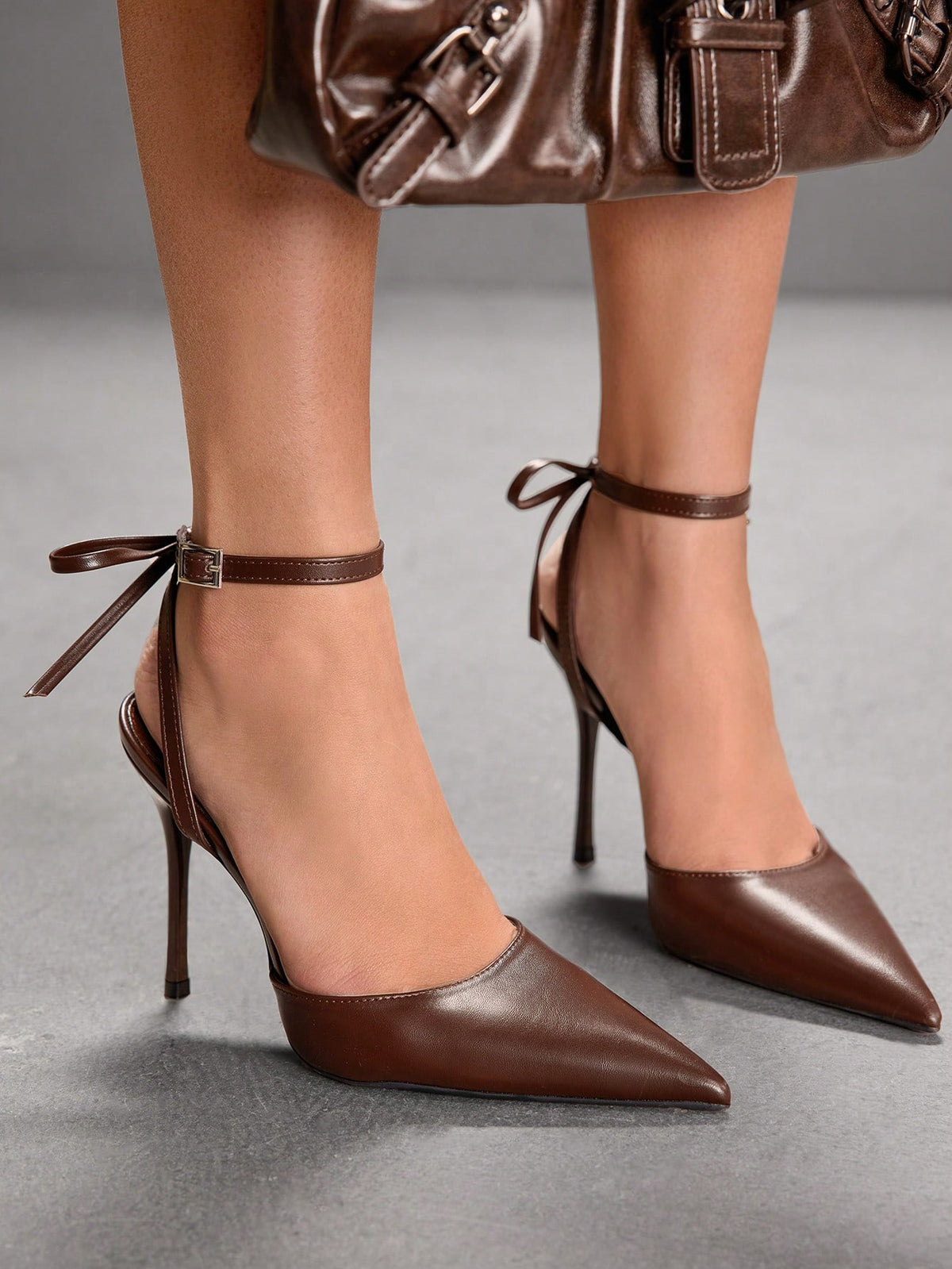 Women's pointed toe ankle strap stiletto high heel pumps featuring smooth PU leather and delicate buckle closure
