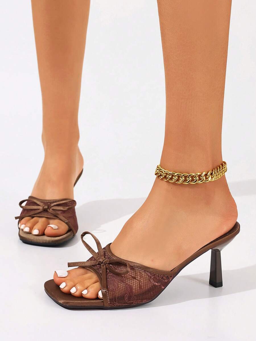 Women's black open toe mesh slide sandals with bowknot detail and stiletto heels