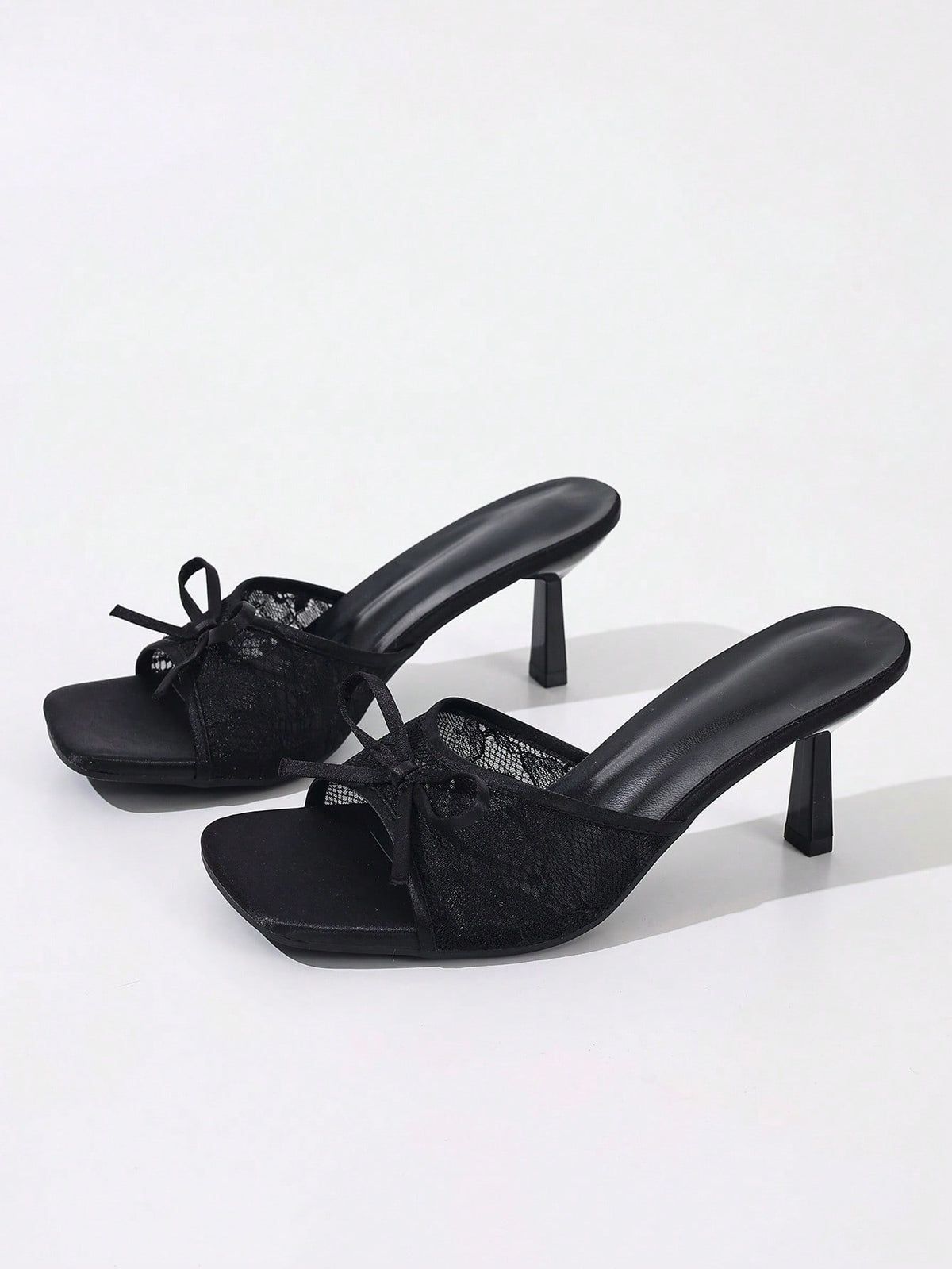 Women's black open toe mesh slide sandals with bowknot detail and stiletto heels