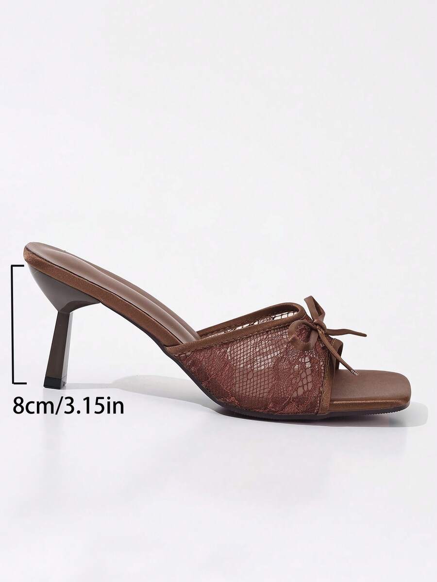 Women's black open toe mesh slide sandals with bowknot detail and stiletto heels