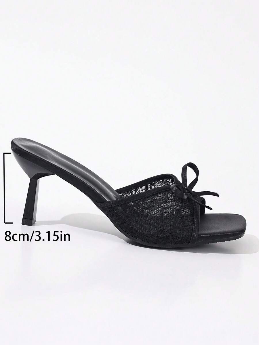 Women's black open toe mesh slide sandals with bowknot detail and stiletto heels