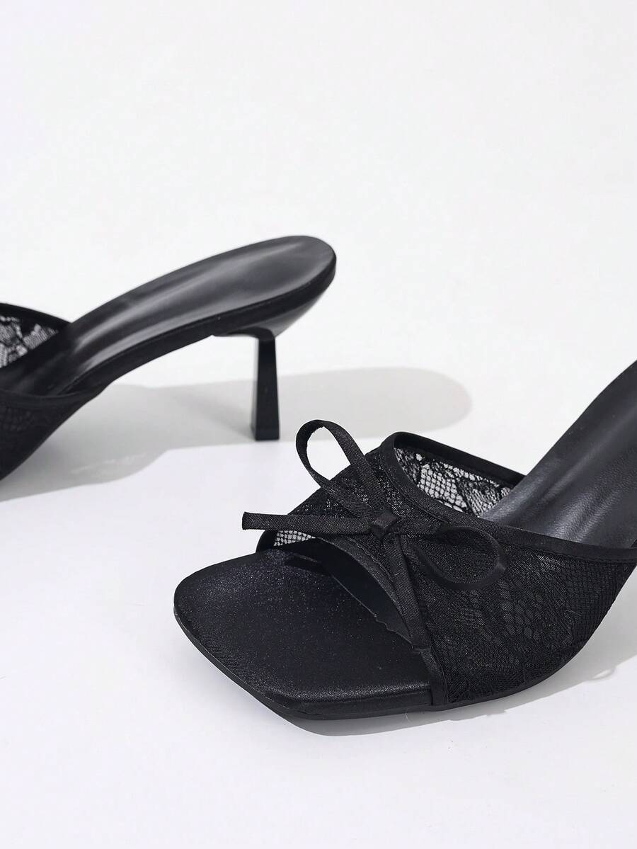 Women's black open toe mesh slide sandals with bowknot detail and stiletto heels