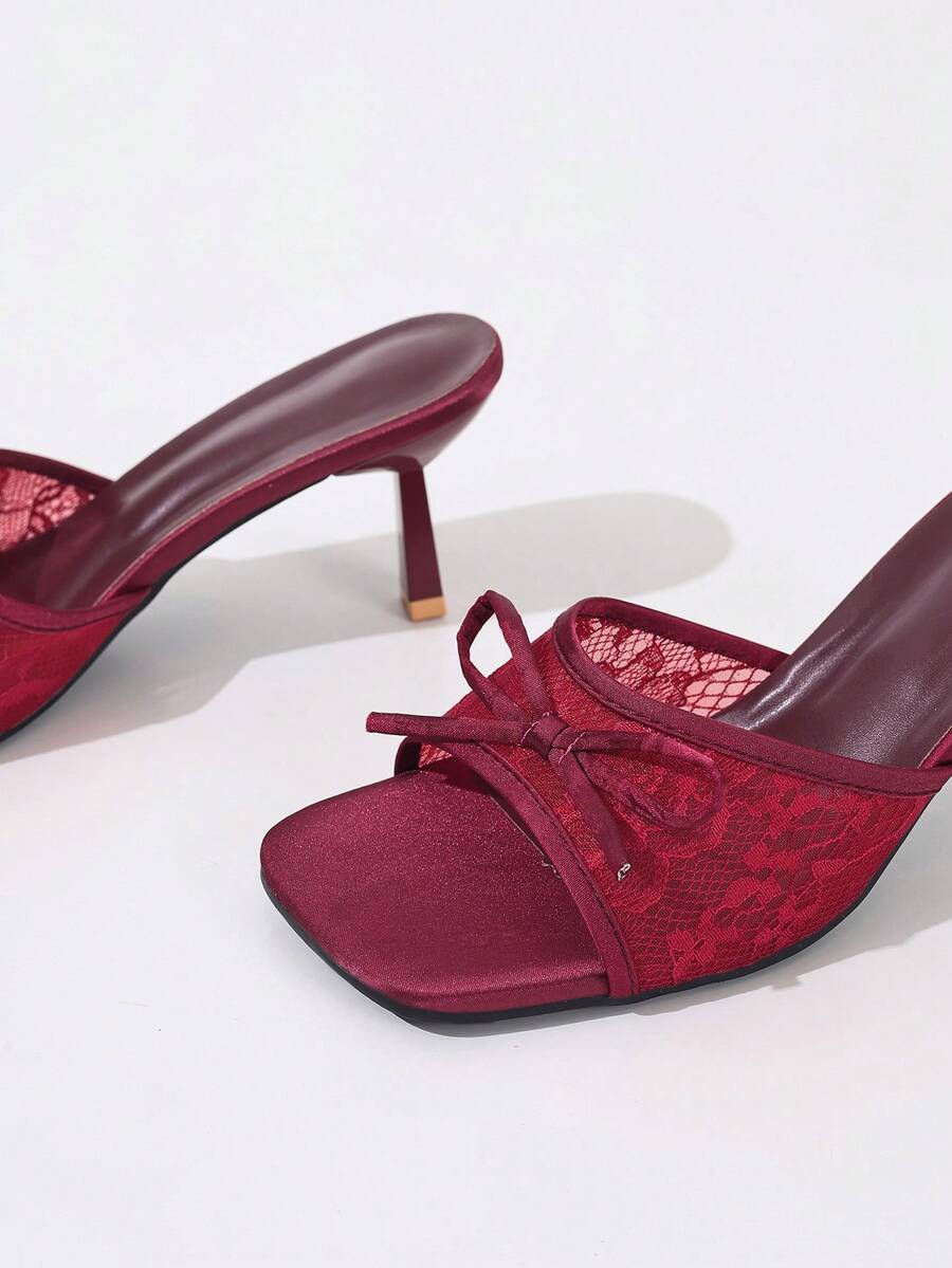 Women's black open toe mesh slide sandals with bowknot detail and stiletto heels