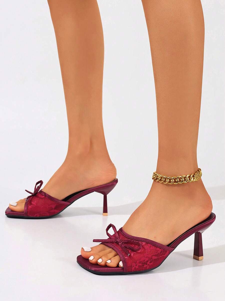 Women's black open toe mesh slide sandals with bowknot detail and stiletto heels