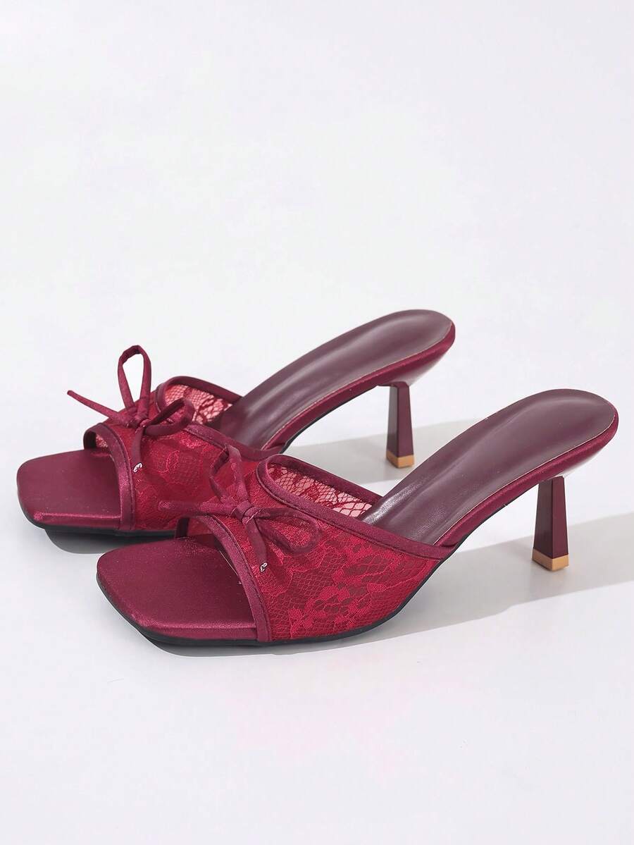 Women's black open toe mesh slide sandals with bowknot detail and stiletto heels