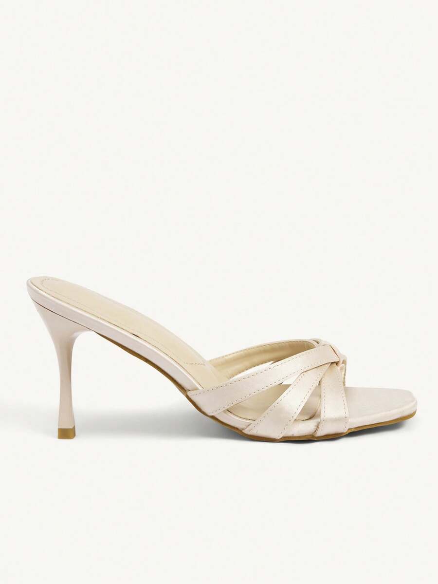 Square toe gold metallic heel sandals for women featuring open toe, crossover slingback strap, and stiletto mid heel for weddings and parties.