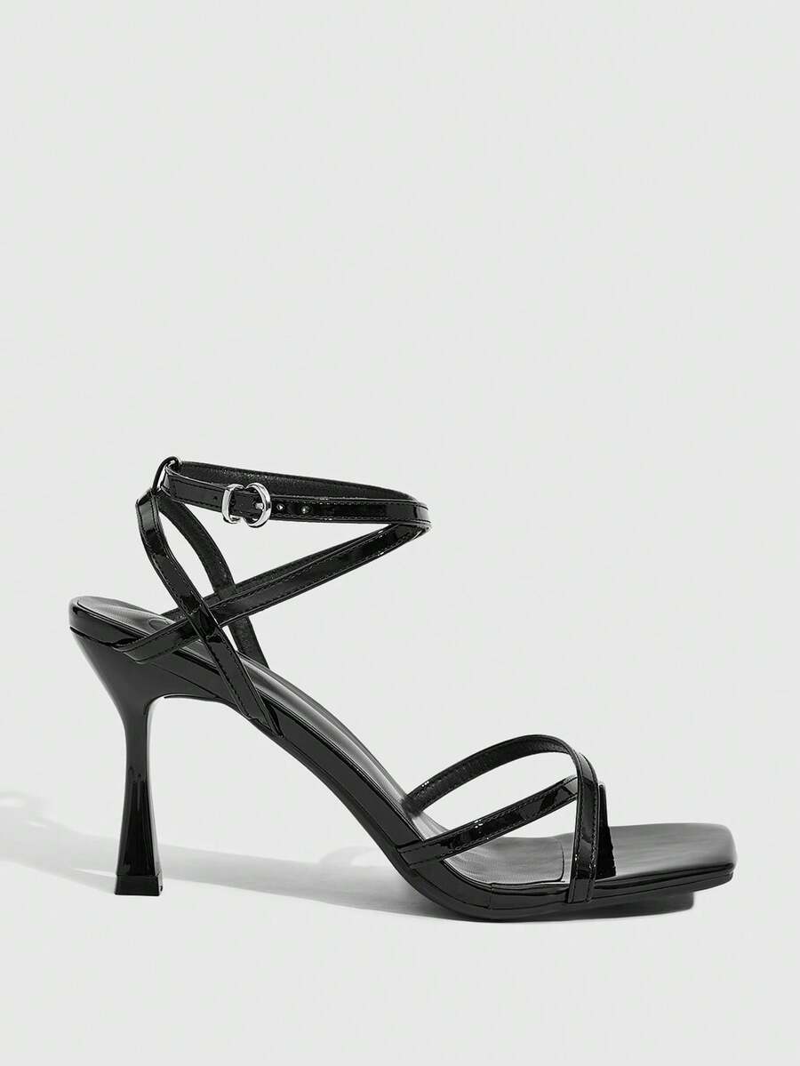 Women's kitten heel sandals featuring criss-cross straps with buckle closure and an open toe design.
