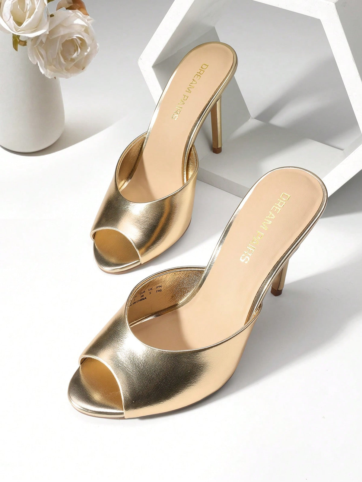 Women's peep toe stiletto mule sandals in white featuring a sleek high heel and slip-on design for party and wedding wear.