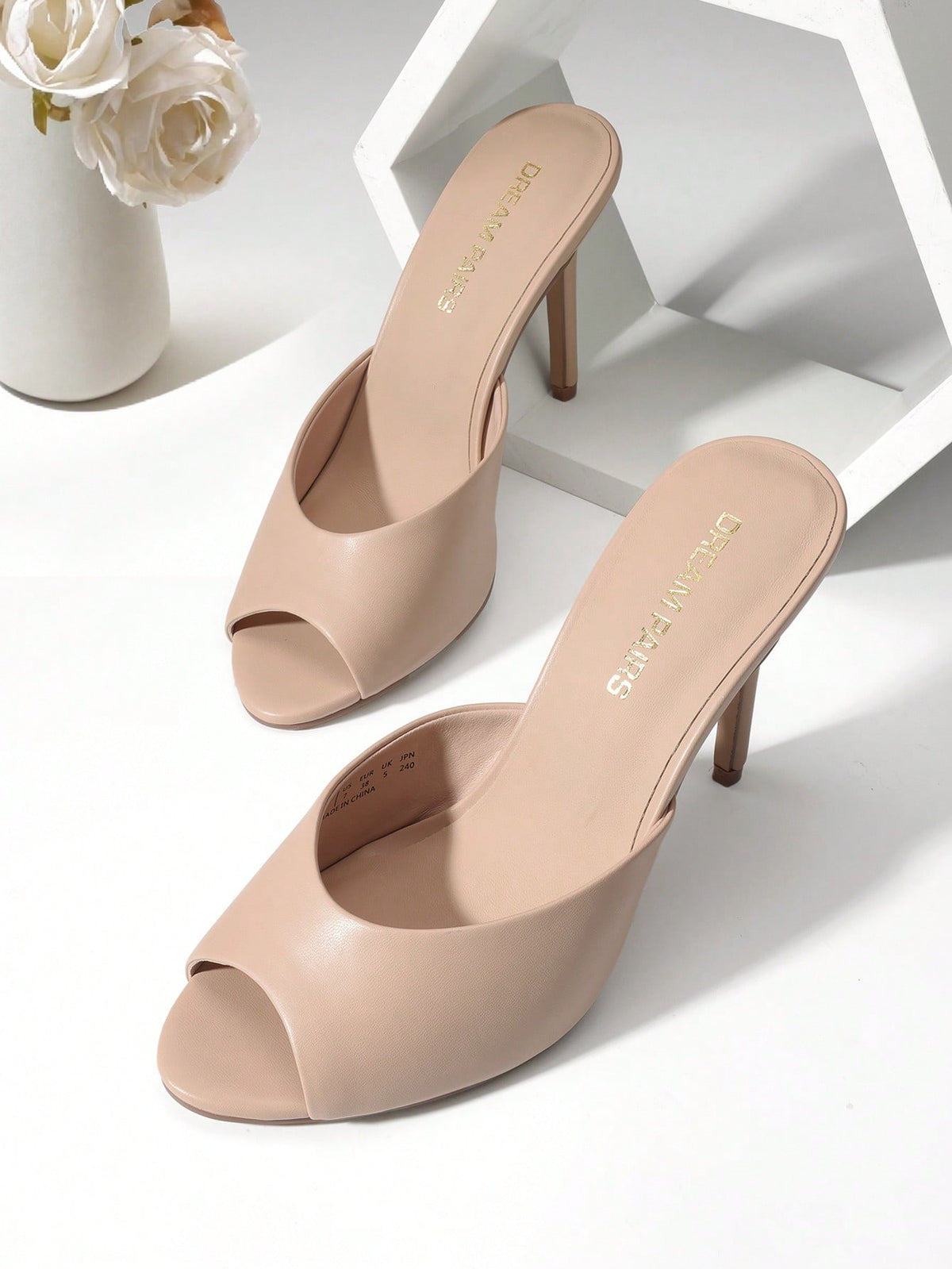 Women's peep toe stiletto mule sandals in white featuring a sleek high heel and slip-on design for party and wedding wear.