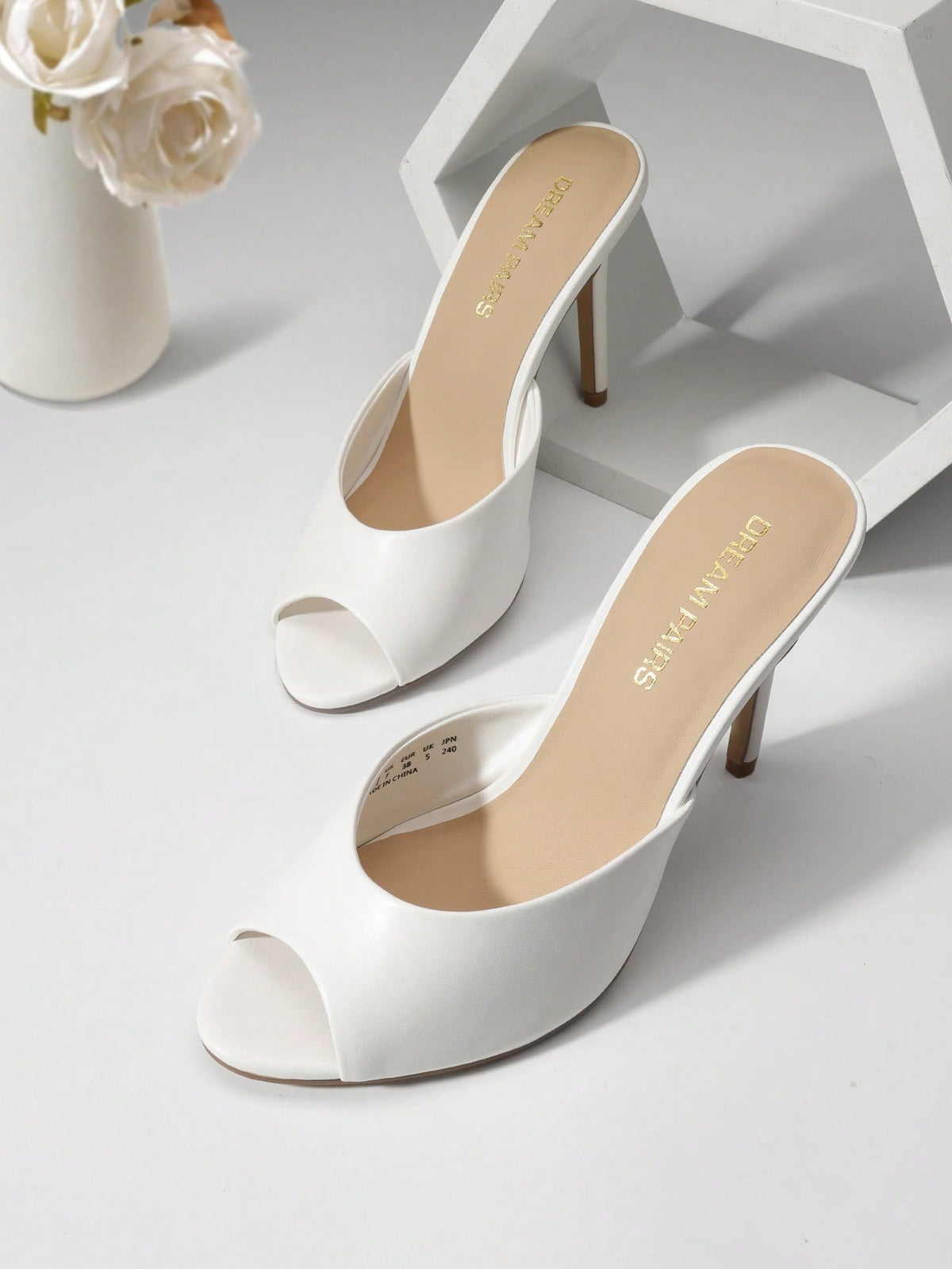 Women's peep toe stiletto mule sandals in white featuring a sleek high heel and slip-on design for party and wedding wear.