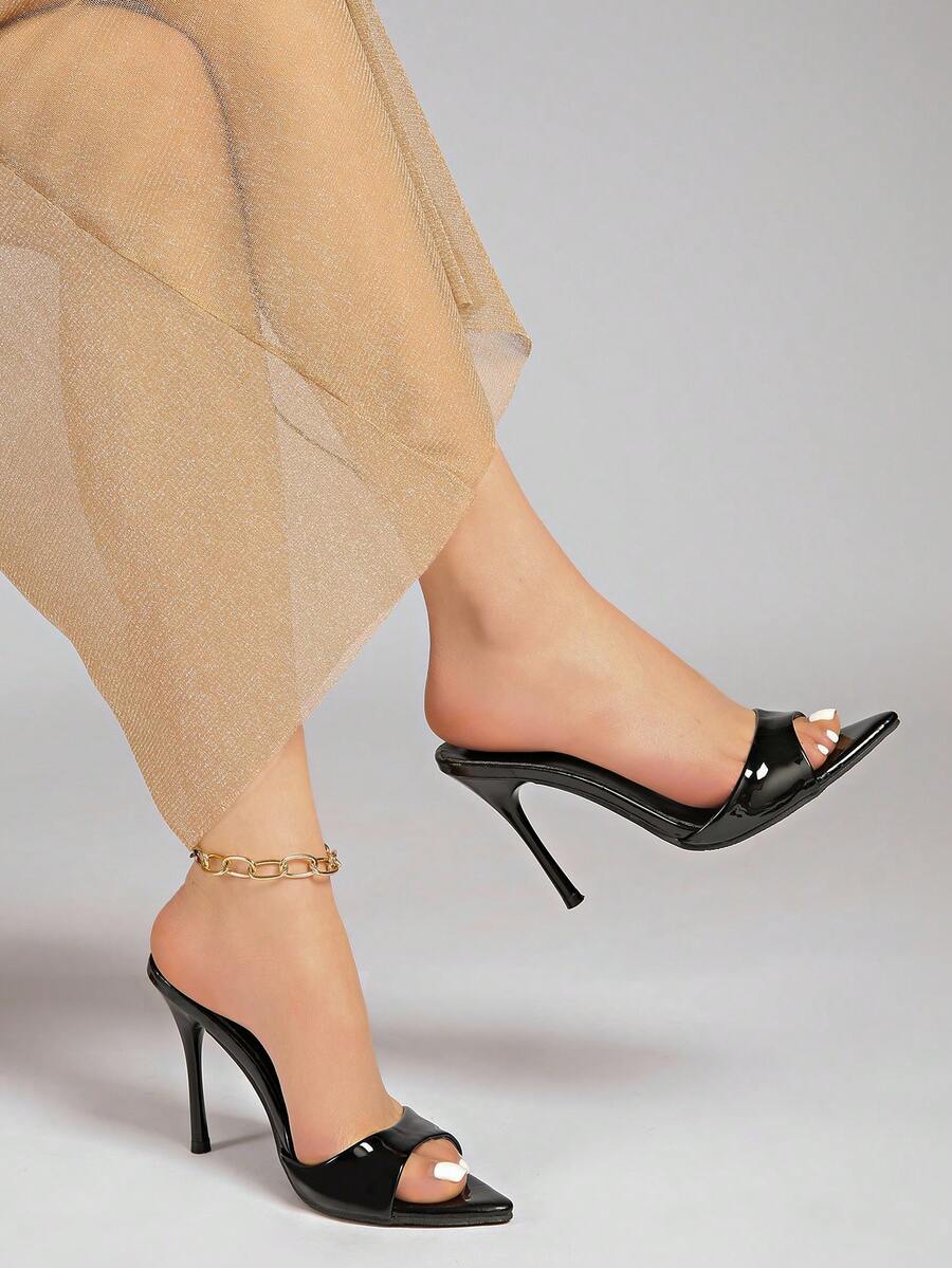 Patent leather open toe slingback slide sandals with stiletto high heels and slip on design.
