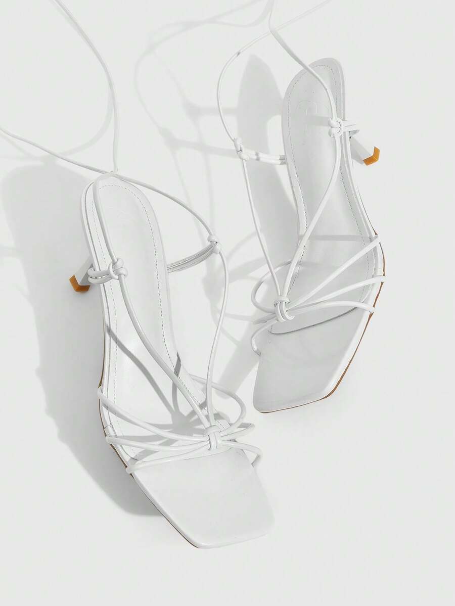 Women's square toe stiletto heel slingback sandals featuring sleek straps and buckle closure in a backless design.