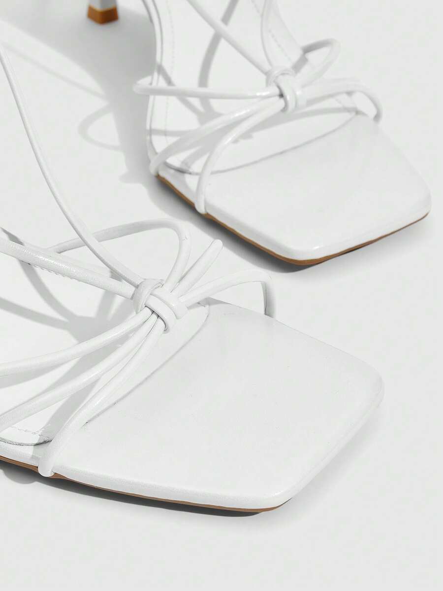 Women's square toe stiletto heel slingback sandals featuring sleek straps and buckle closure in a backless design.