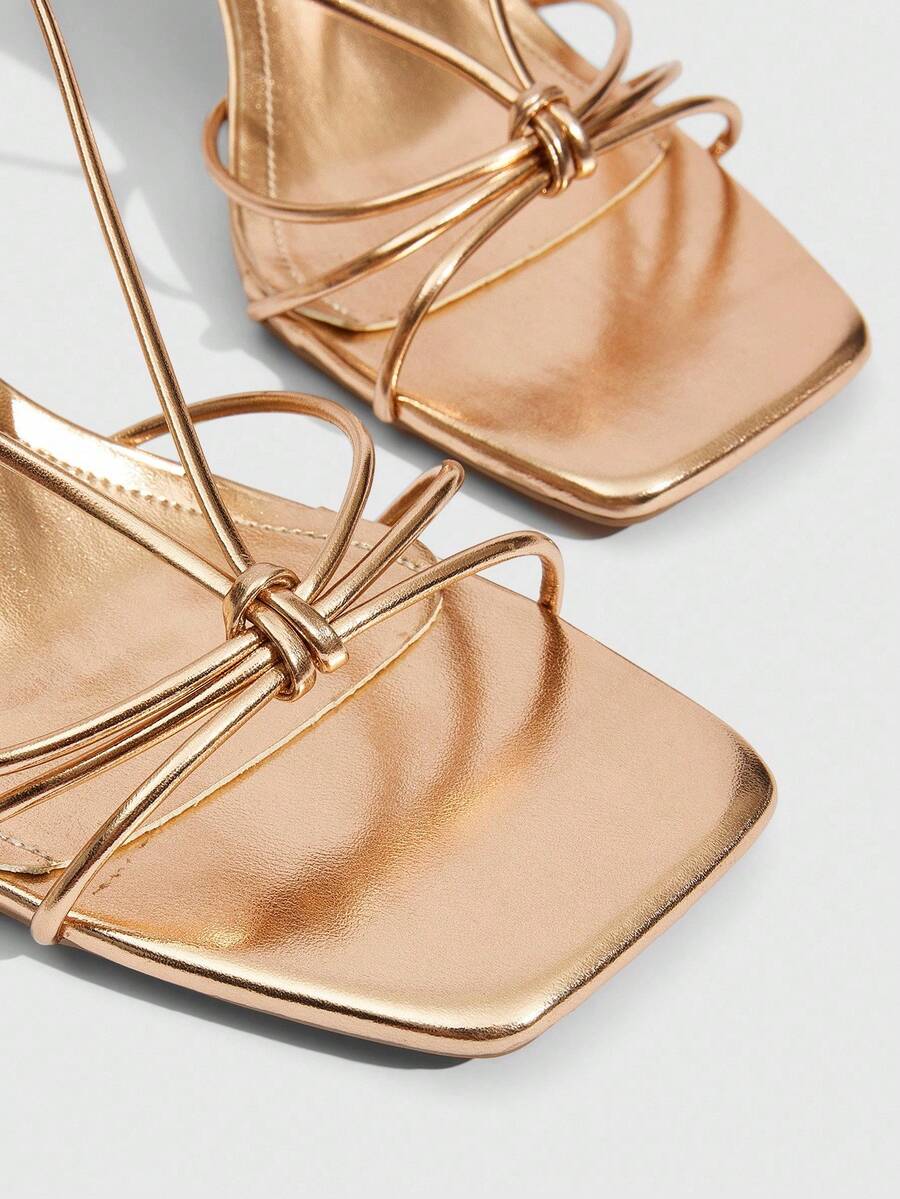 Women's square toe stiletto heel slingback sandals featuring sleek straps and buckle closure in a backless design.