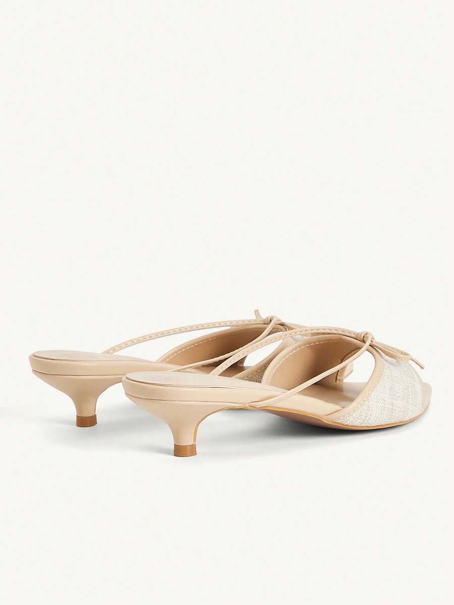 Pointed toe high-heeled slippers in PU leather with decorative buckle detail and low kitten heels for women.