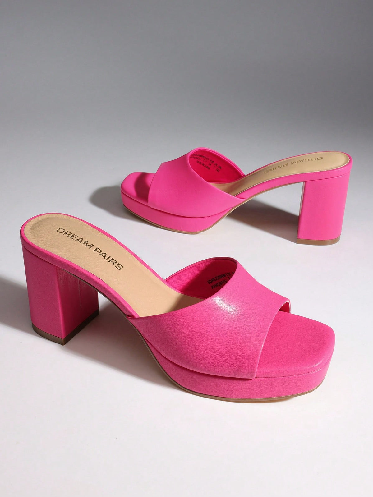 Women's minimalist open toe mule sandals featuring a chunky low heel, wide single strap, and slip-on design.