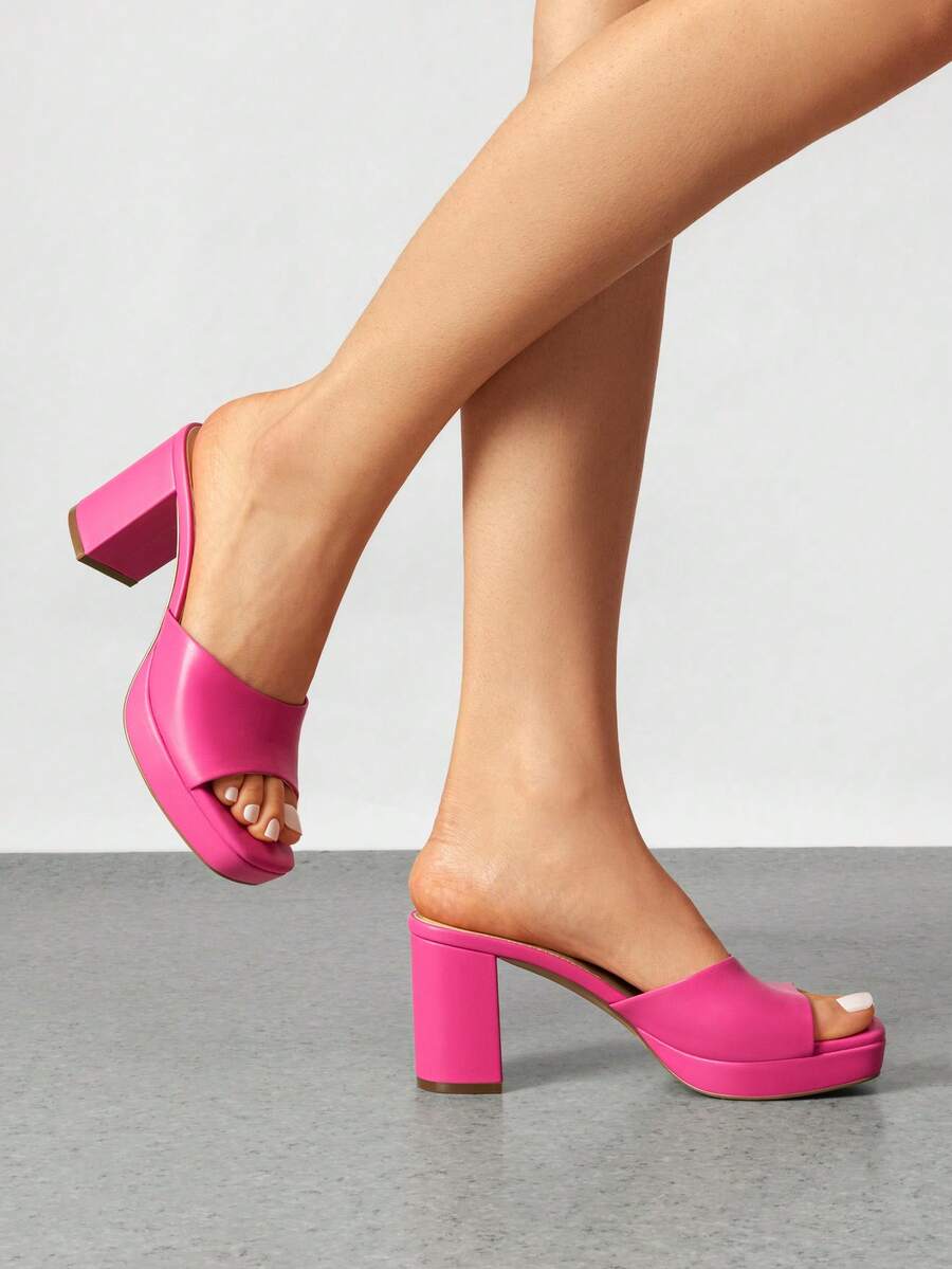 Women's minimalist open toe mule sandals featuring a chunky low heel, wide single strap, and slip-on design.