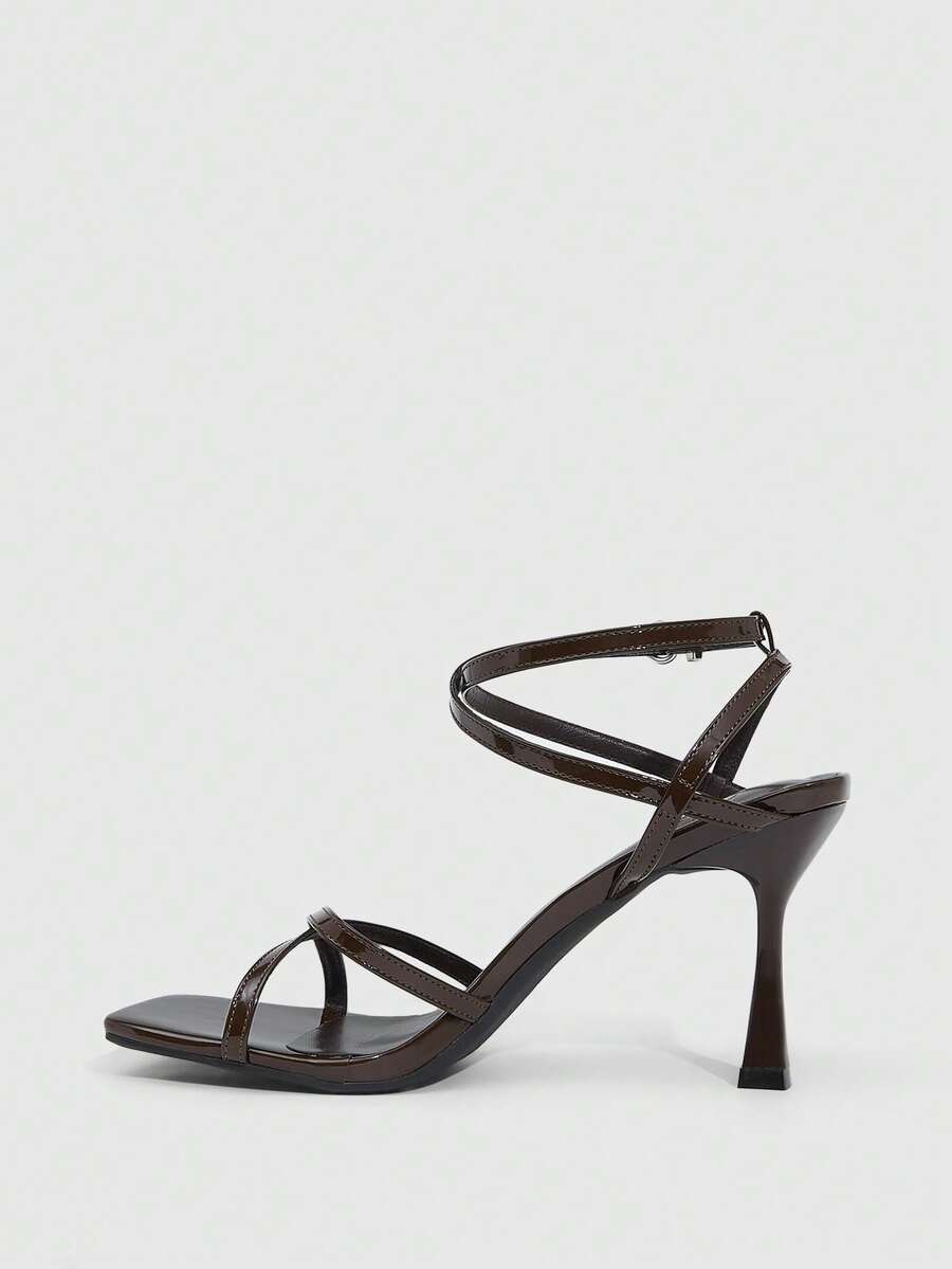 Women's kitten heel sandals featuring criss-cross straps with buckle closure and an open toe design.