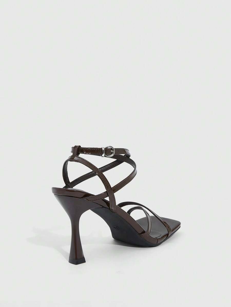 Women's kitten heel sandals featuring criss-cross straps with buckle closure and an open toe design.
