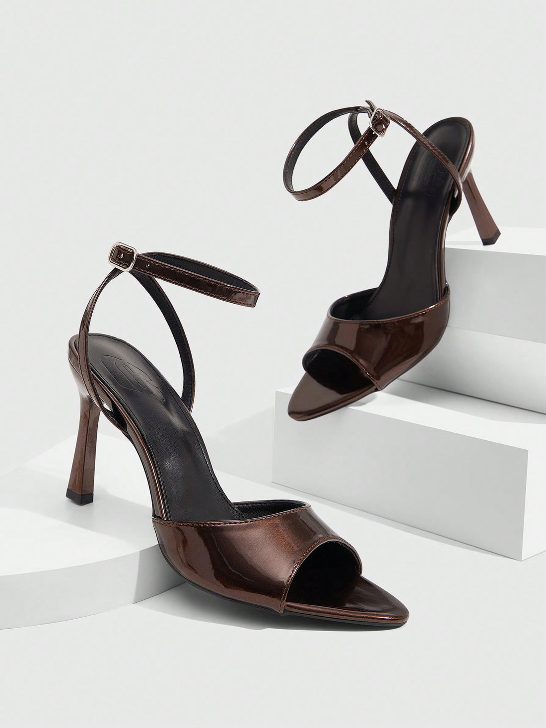 Minimalist women's open toe high heel sandals featuring a slender stiletto heel and adjustable ankle strap buckle closure.