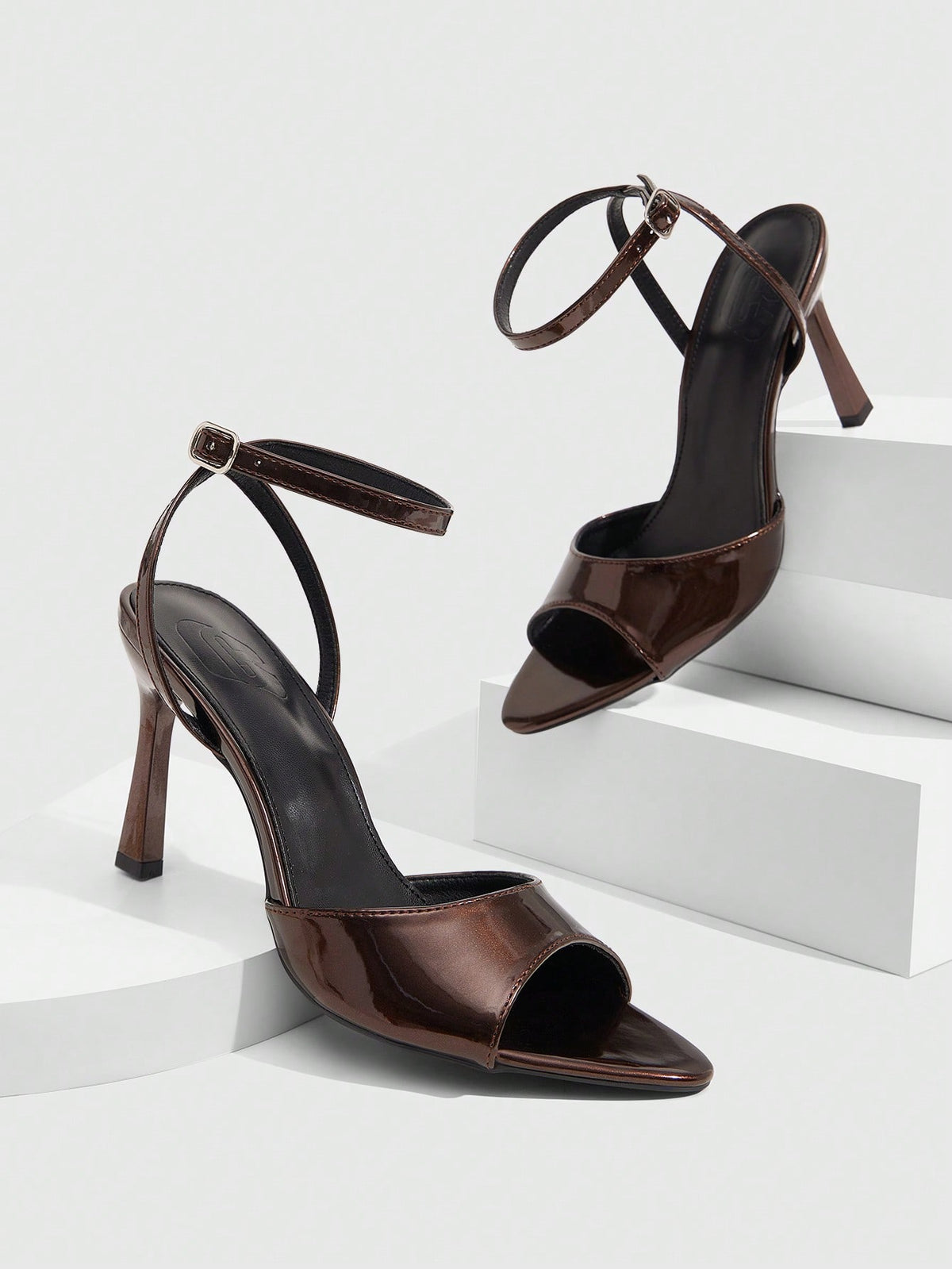 Minimalist women's open toe high heel sandals featuring a slender stiletto heel and adjustable ankle strap buckle closure.
