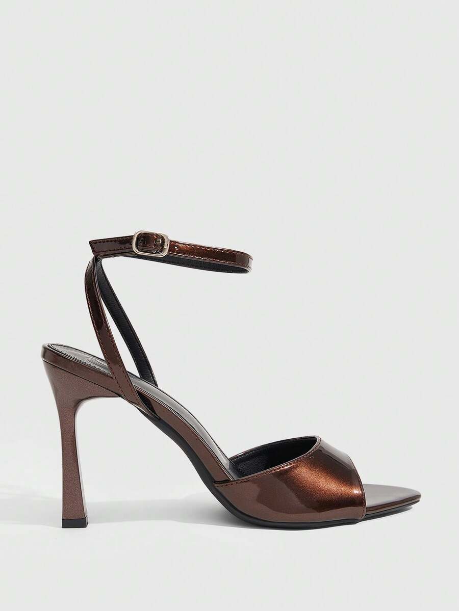 Minimalist women's open toe high heel sandals featuring a slender stiletto heel and adjustable ankle strap buckle closure.