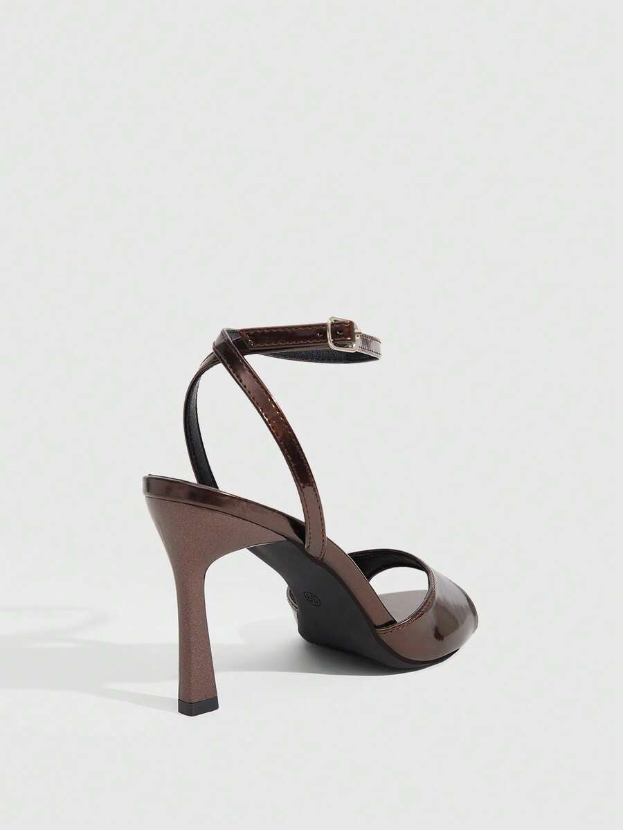 Minimalist women's open toe high heel sandals featuring a slender stiletto heel and adjustable ankle strap buckle closure.