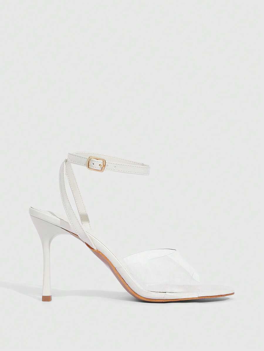 Pair of women's black high heel sandals with open toe design, slim stiletto heel, and adjustable ankle buckle strap.