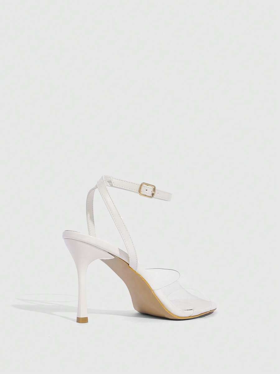 Pair of women's black high heel sandals with open toe design, slim stiletto heel, and adjustable ankle buckle strap.