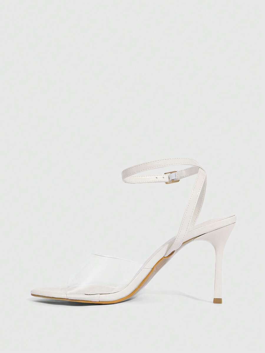 Pair of women's black high heel sandals with open toe design, slim stiletto heel, and adjustable ankle buckle strap.