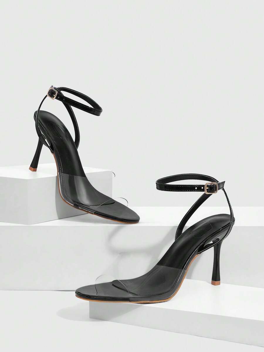 Pair of women's black high heel sandals with open toe design, slim stiletto heel, and adjustable ankle buckle strap.