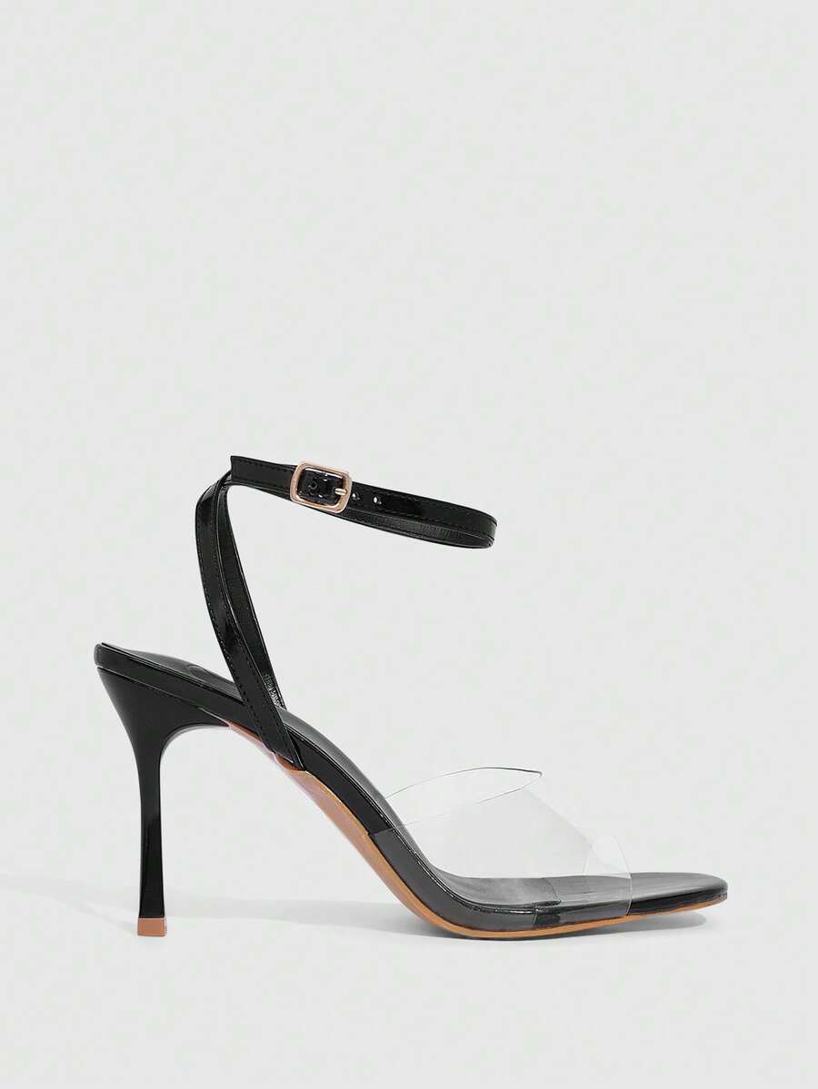 Pair of women's black high heel sandals with open toe design, slim stiletto heel, and adjustable ankle buckle strap.