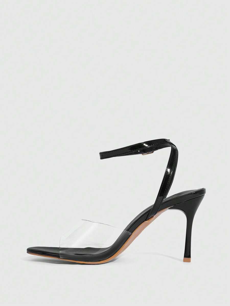 Pair of women's black high heel sandals with open toe design, slim stiletto heel, and adjustable ankle buckle strap.