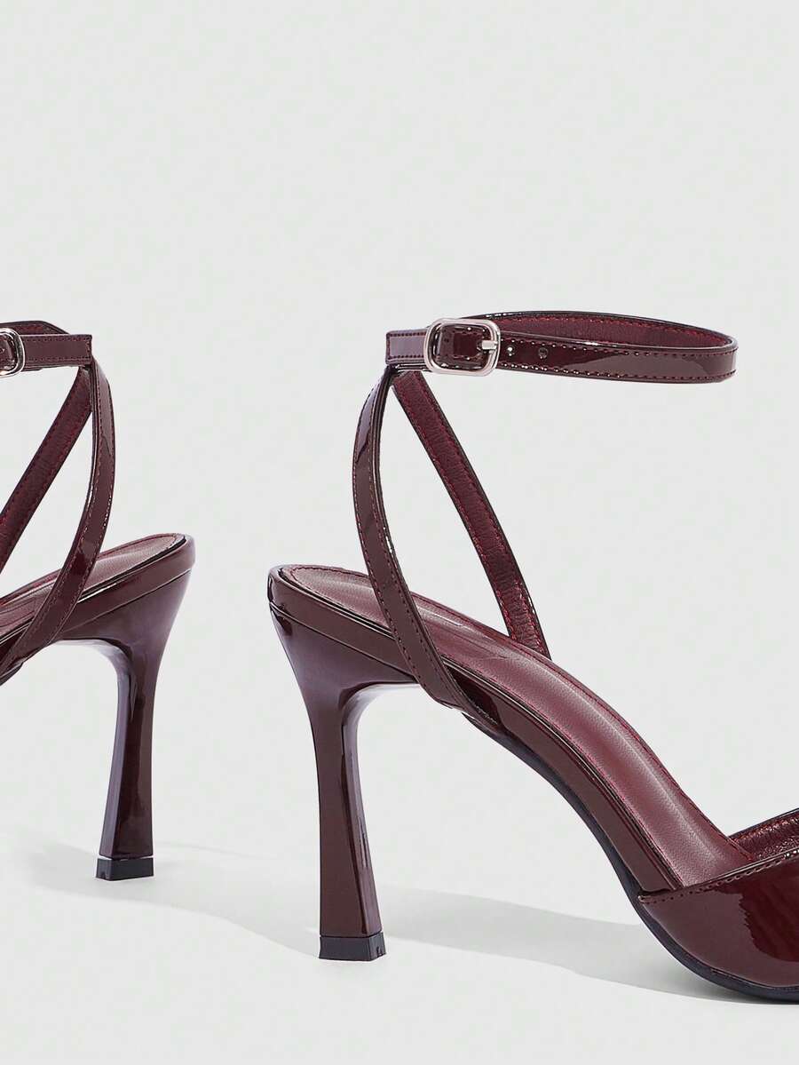Minimalist women's open toe high heel sandals featuring a slender stiletto heel and adjustable ankle strap buckle closure.