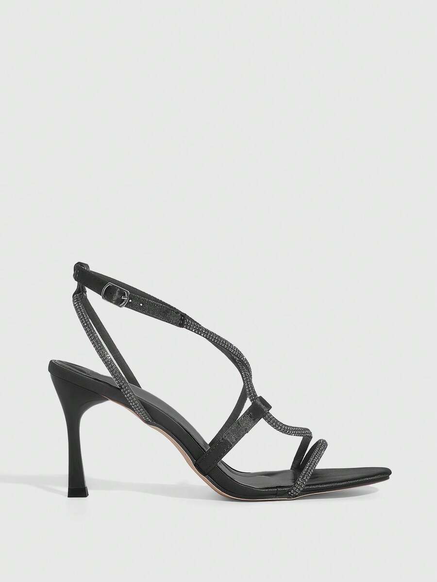 Women's pointed toe high heel sandals embellished with sparkling rhinestones, stiletto heels, and ankle strap buckle closure.