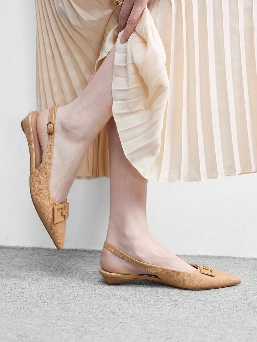 Women's pointed toe low wedge flat shoes crafted in PU leather with a slingback strap and stylish metal buckle detail.