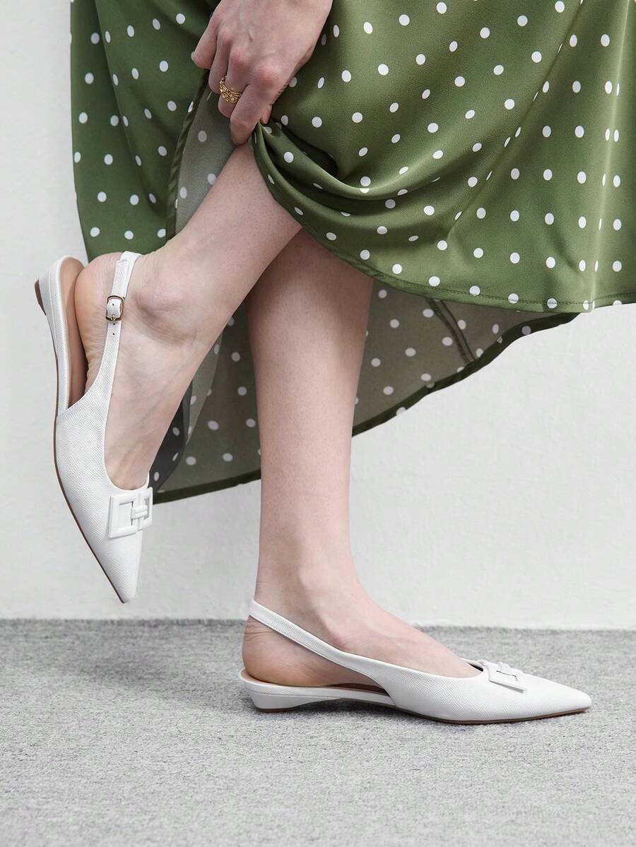 Women's pointed toe low wedge flat shoes crafted in PU leather with a slingback strap and stylish metal buckle detail.