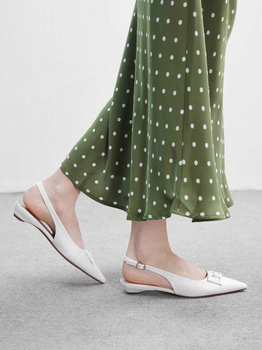 Women's pointed toe low wedge flat shoes crafted in PU leather with a slingback strap and stylish metal buckle detail.