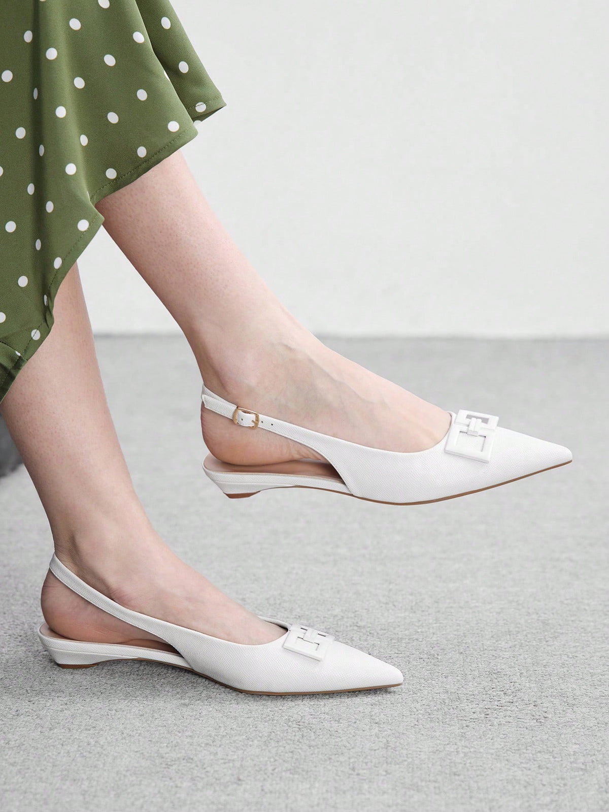 Women's pointed toe low wedge flat shoes crafted in PU leather with a slingback strap and stylish metal buckle detail.